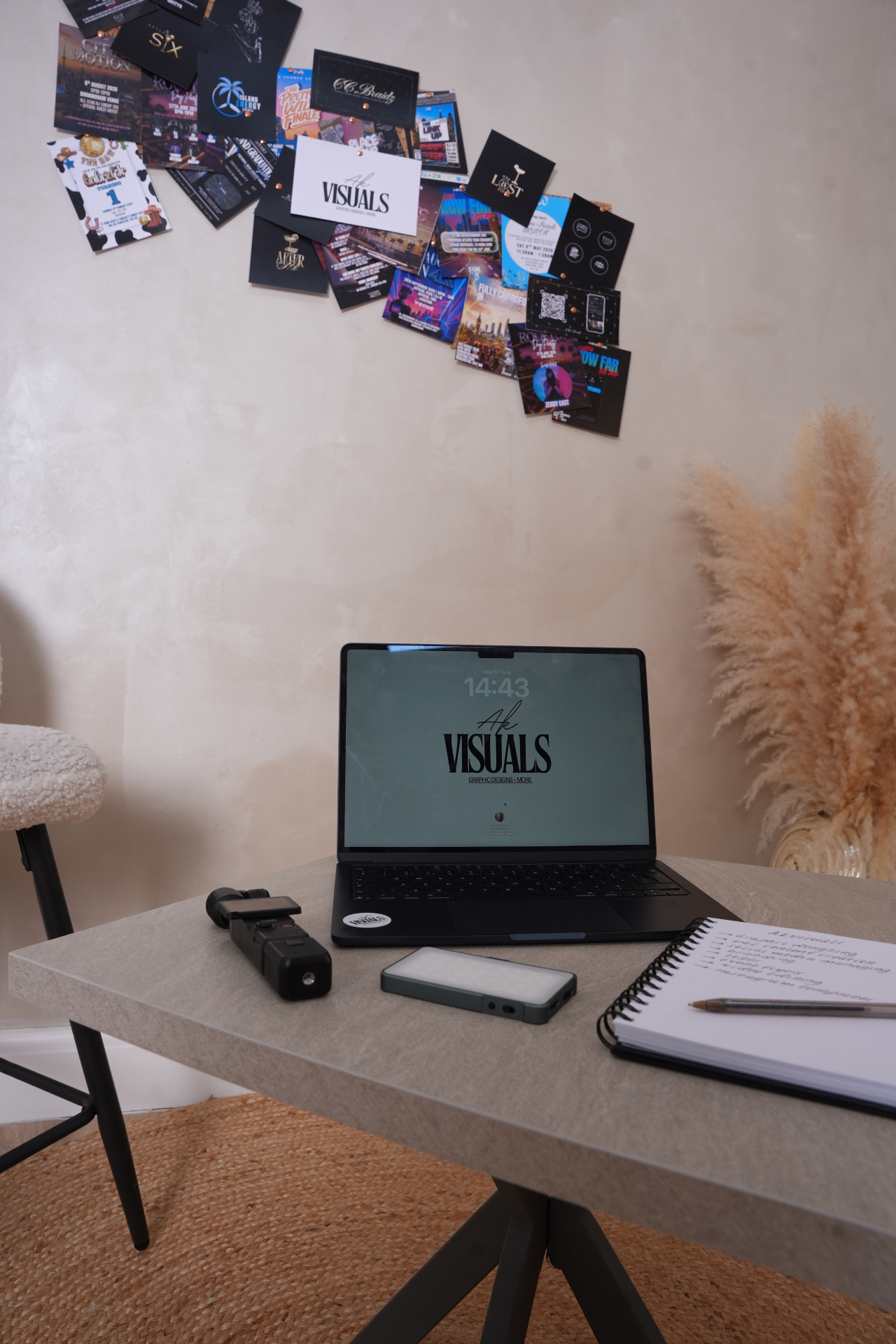 Studio desk with laptop, camera, light and a notebook of ideas